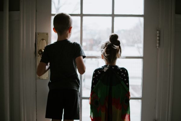 two children look out of a window